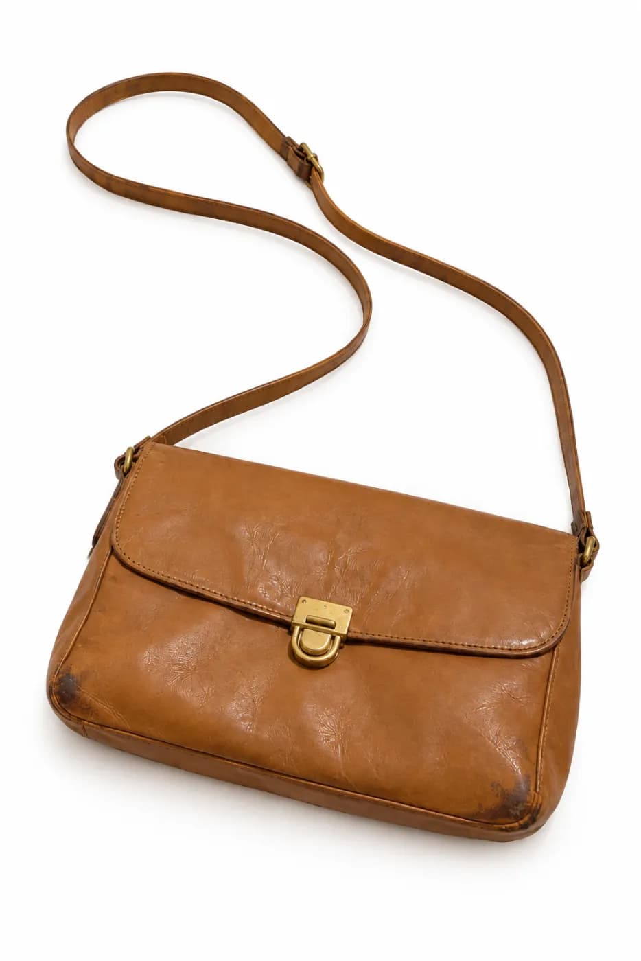 The same bag on a plain white background, with its worn corners still showing